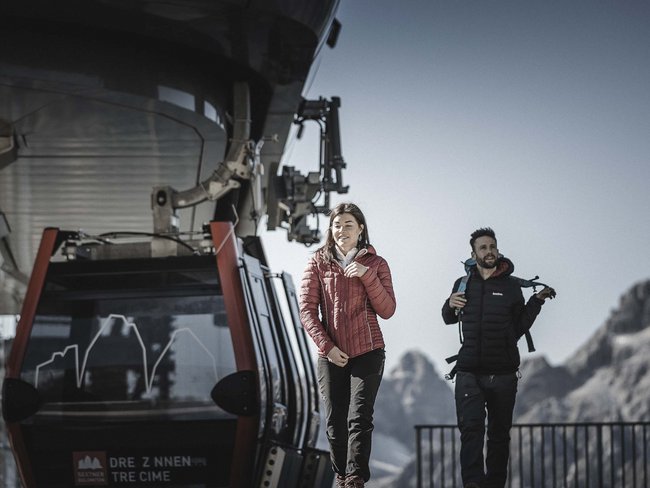 Alpen Tesitin, our hiking hotel in Val Pusteria/Pustertal Two hikers exit a cable car in the Dolomites