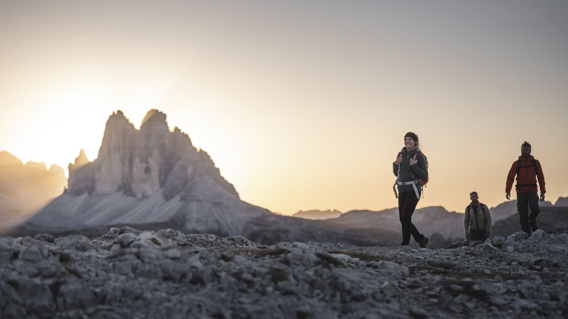 Action & adventure in Alta Pusteria/Hochpustertal Three hikers at sunset in the Dolomite mountains