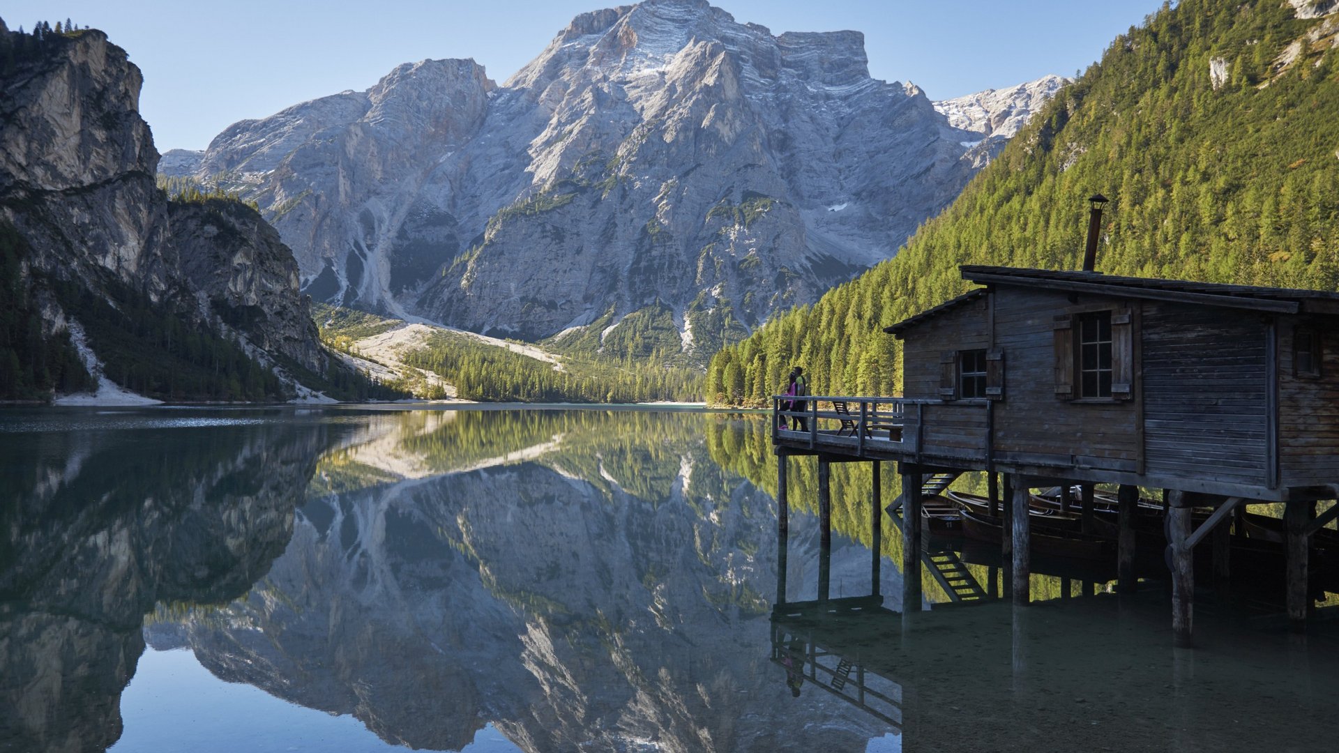 Alpen Tesitin, our hiking hotel in Val Pusteria/Pustertal Mountain lake with wooden house on stilts and mountain reflection in water