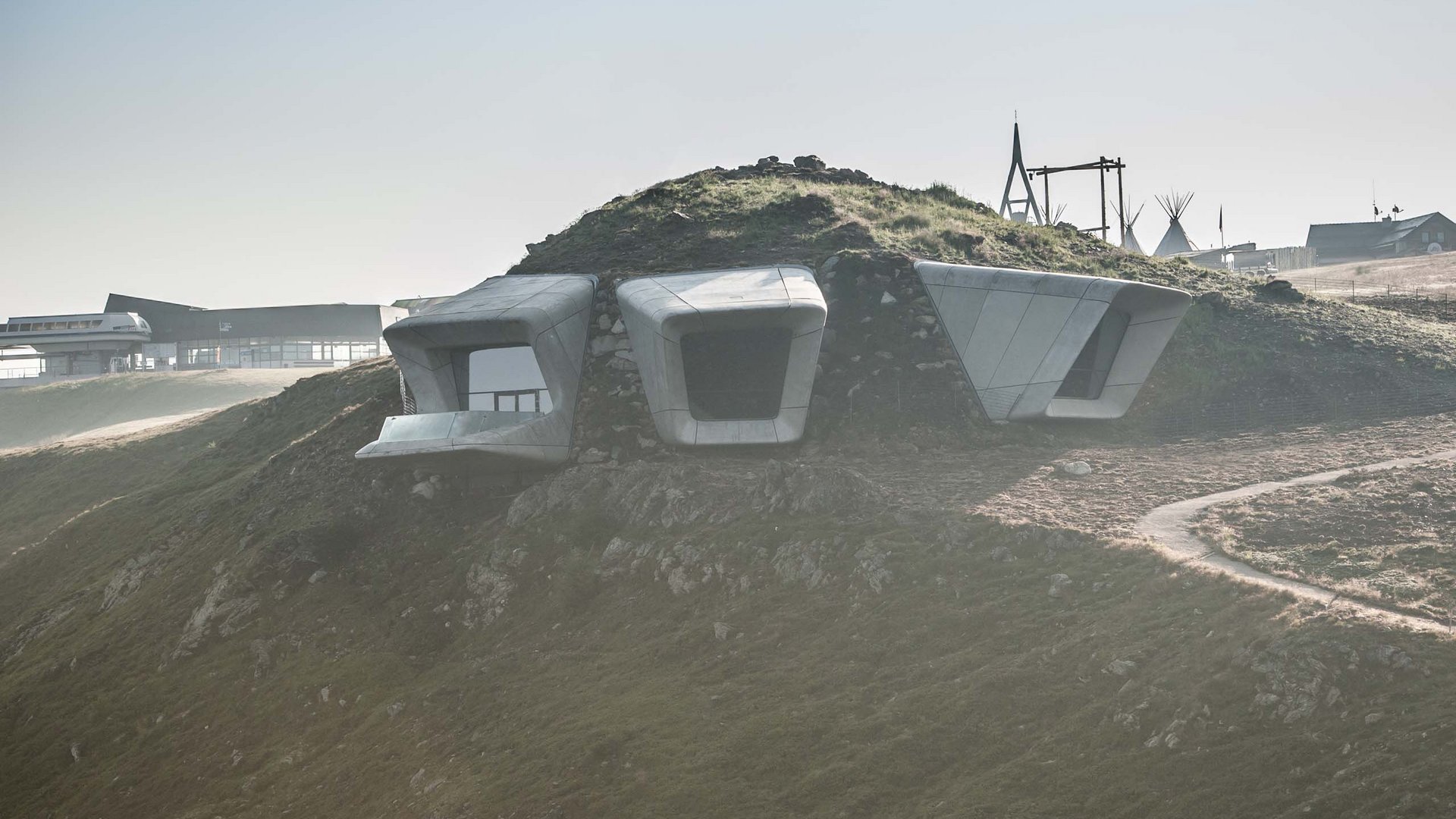 These attractions await you in Val Pusteria/Pustertal! Modern concrete structures on a grassy sloped hill