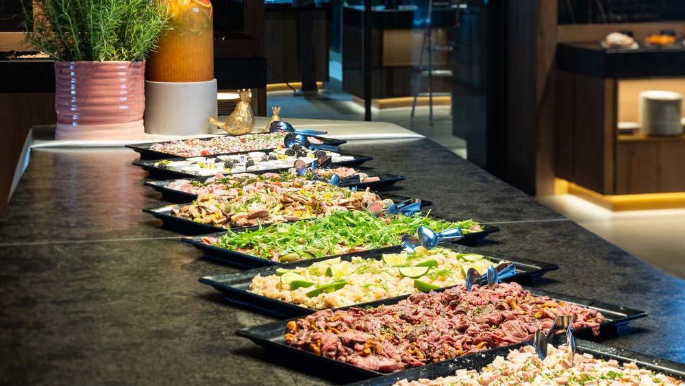 Le foto più belle dell’Alpen Tesitin Buffet con vari insalate e piatti freddi su piatti neri