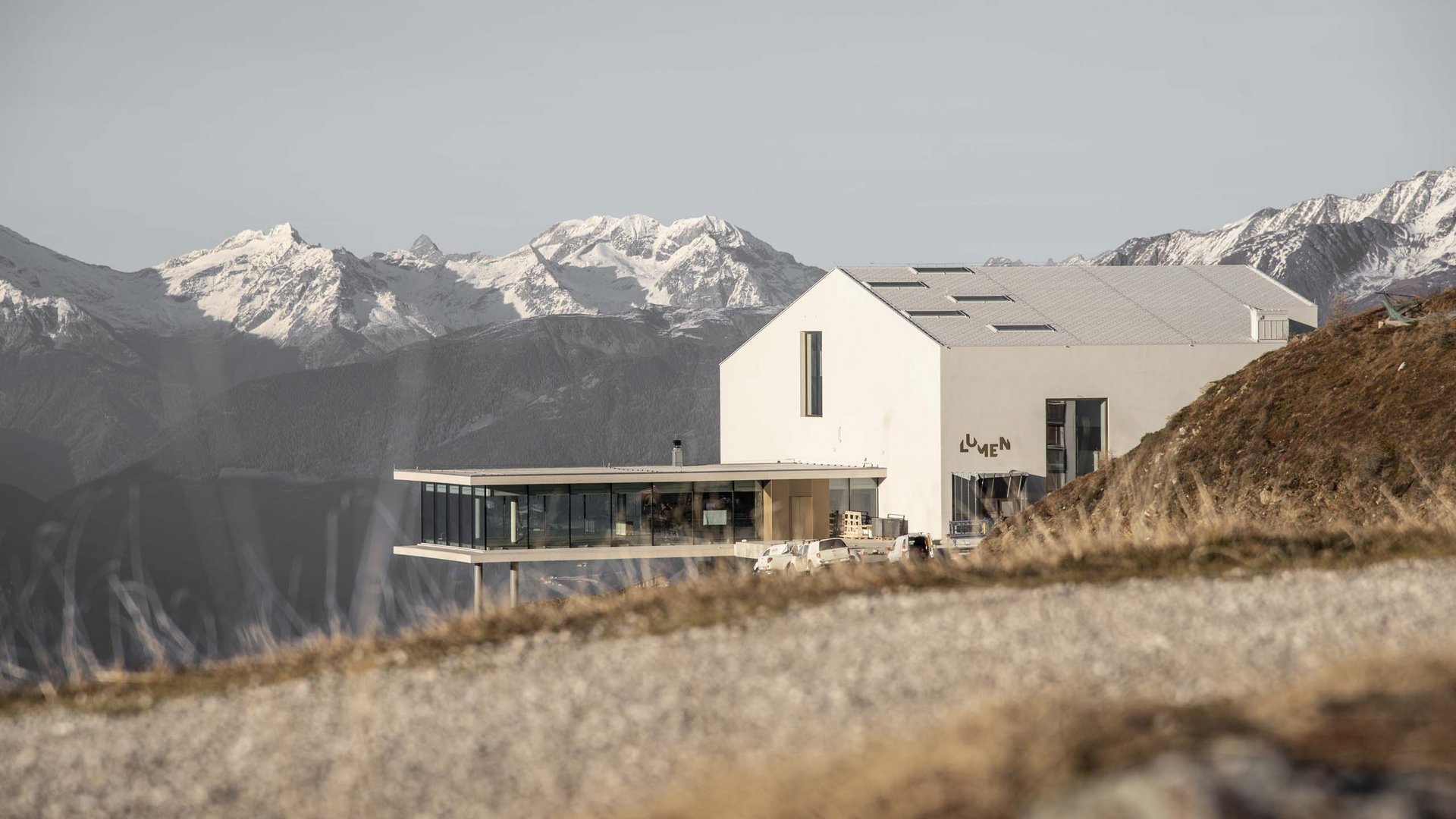 These attractions await you in Val Pusteria/Pustertal! Modern alpine building with mountain panorama and snow in the background