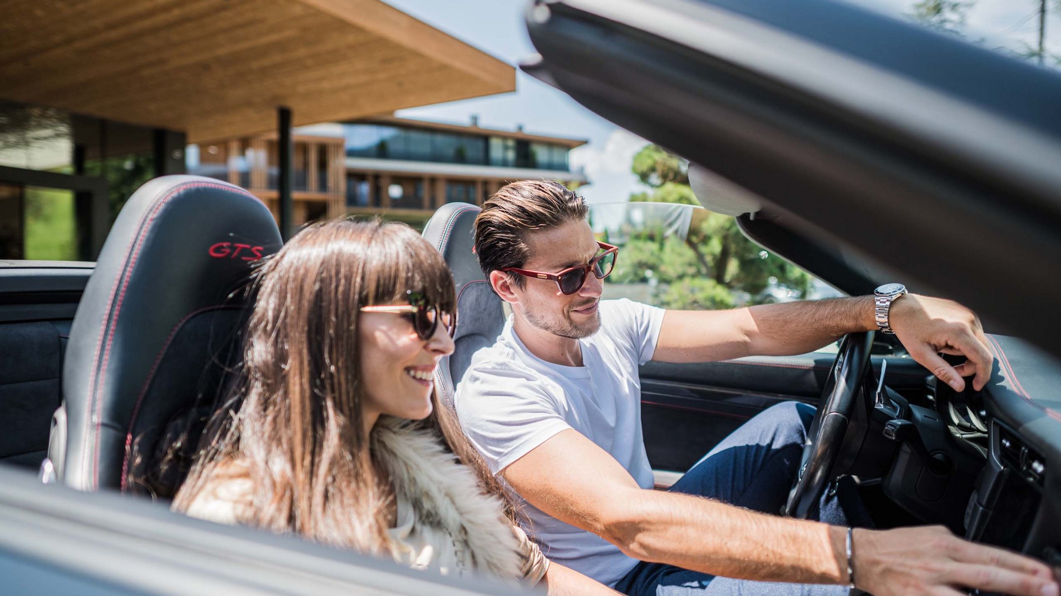 Alpen Tesitin: Your 5-star hotel in the Dolomites Young couple driving a convertible on a sunny day